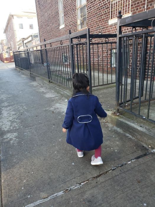 A reviewer's child wearing the coat in navy blue.