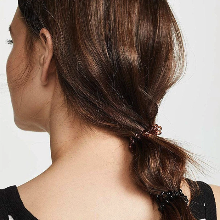 a model showcasing brown and black spiral hair ties in her ponytail