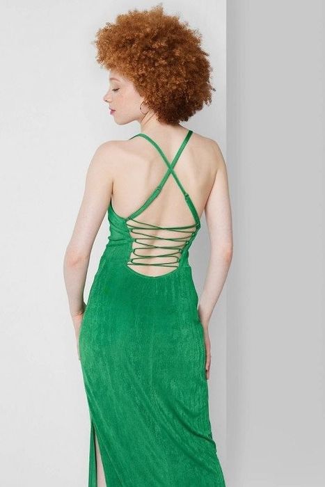 Model showcasing the green dress