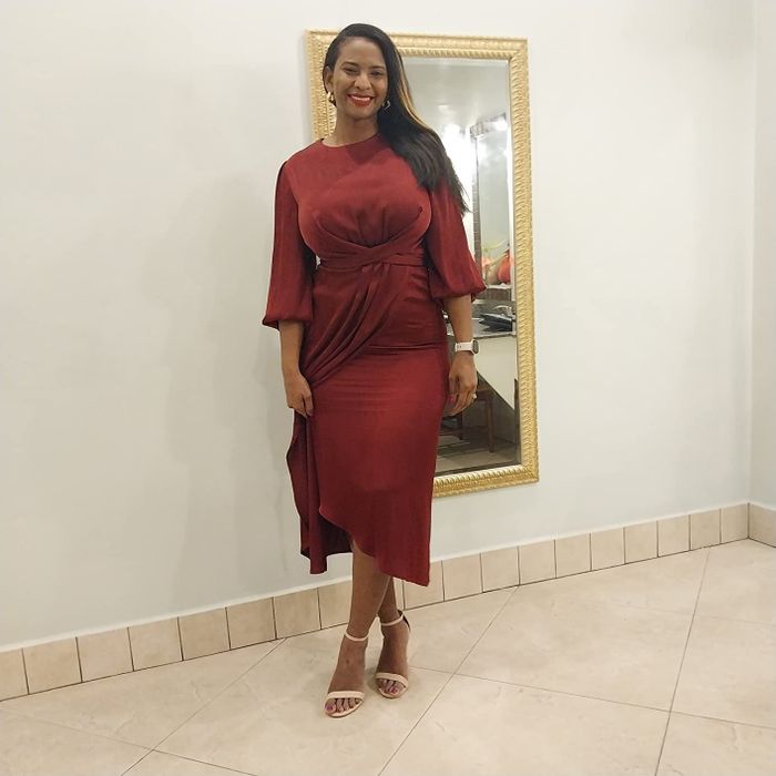 another reviewer in a red midi dress