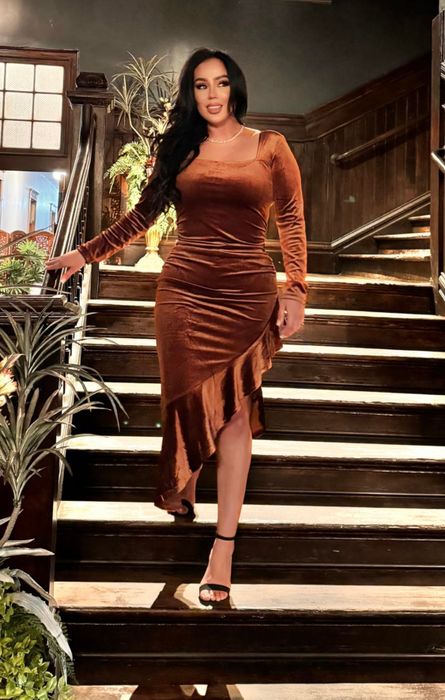 reviewer wearing a tan velvet mermaid dress