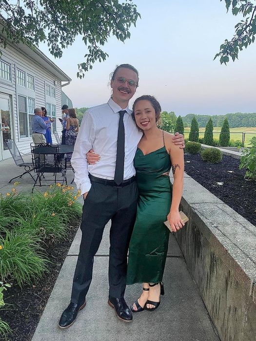 A reviewer wearing the dark green slip dress