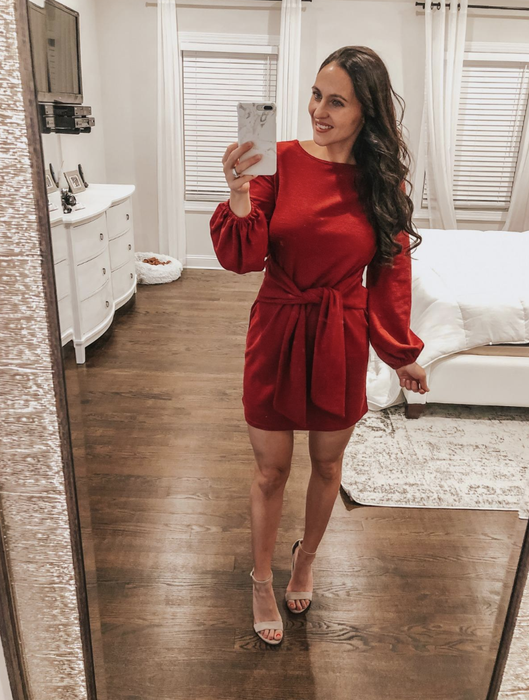 Reviewer showcasing the red variant of the dress
