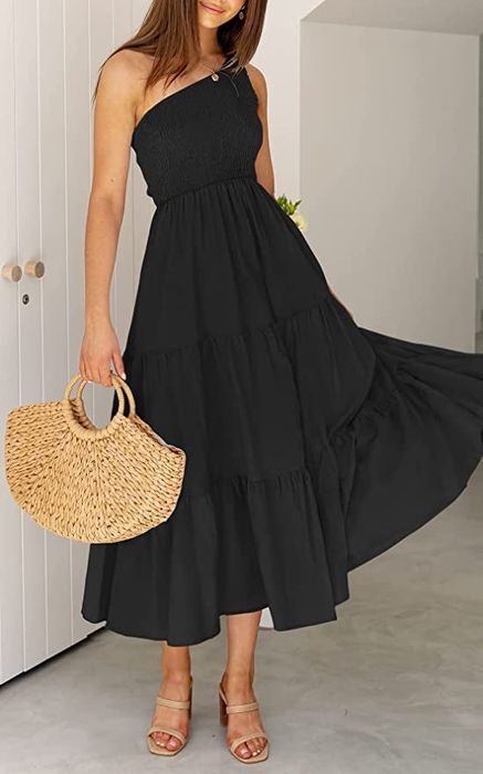 A model wearing the black one-shoulder midi dress