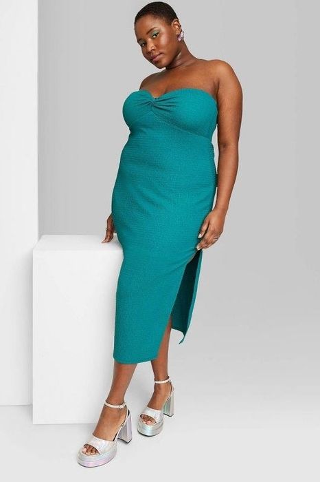 Model showcasing the dark teal green dress