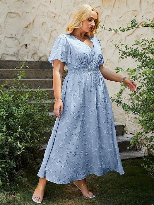 The same model showcasing the dress in a delicate light blue hue