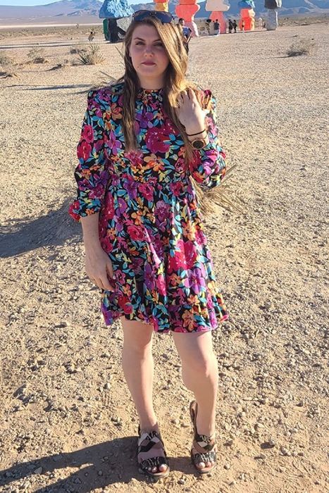 a reviewer modeling the dress in a desert setting