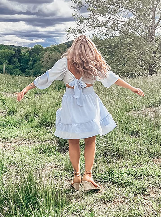 Back view of a reviewer in the light blue dress showcasing the tie-back detail