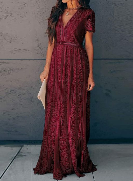 A model wearing the burgundy dress adorned with intricate lace-like details