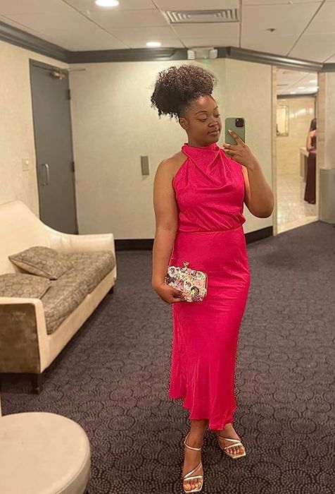 A reviewer wearing the pink draped mock neck maxi dress, highlighting its elegance and comfort.