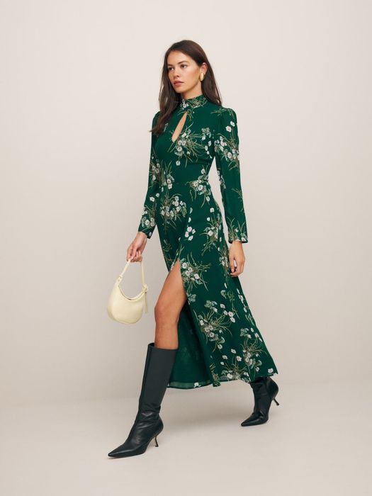 same model wearing the dress in a green floral print