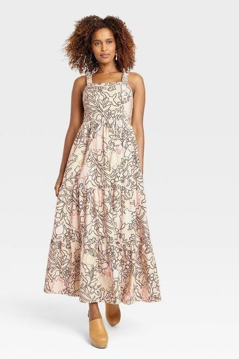 Model showcasing the tan floral dress