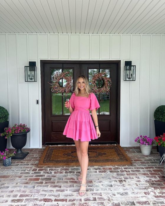 reviewer in a pink dress