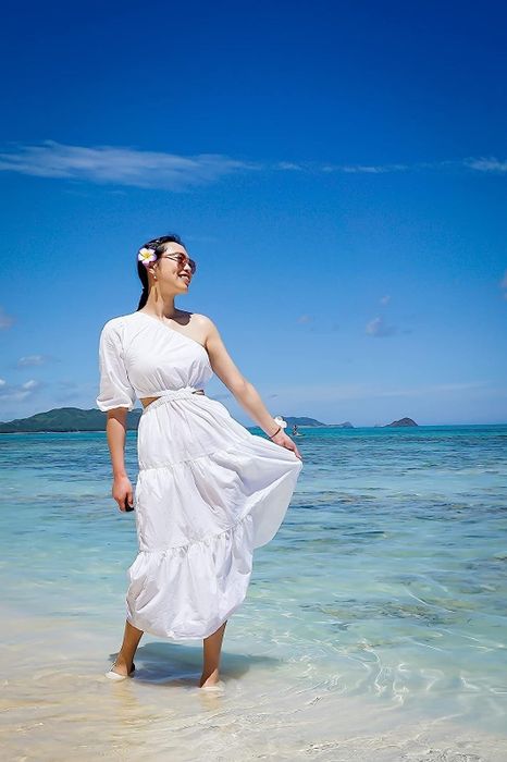 A reviewer in the white cutout dress, sharing their experience with its chic design, flattering fit, and perfect summer appeal.