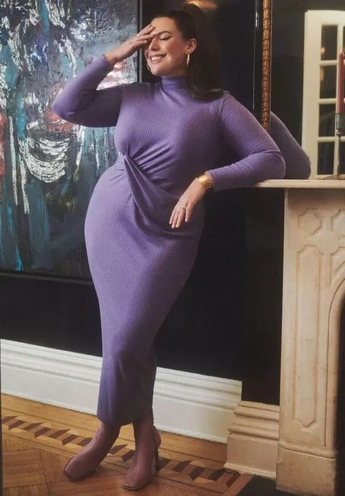 The model is showcasing a purple maxi dress with an eye-catching knot design.