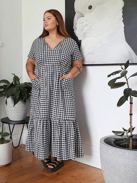 model posing in a checked dress