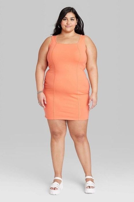 Model showcasing the orange dress