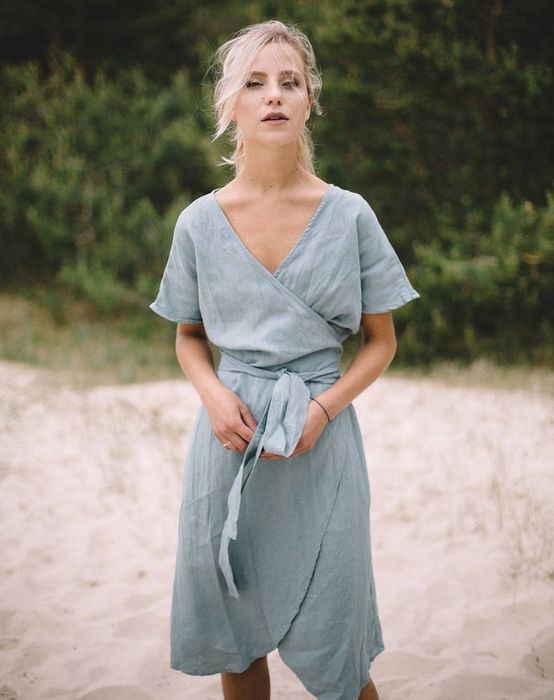 model showcasing the short-sleeved wrap dress in light blue