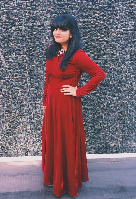 reviewer wearing the red version of the dress