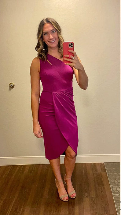 A reviewer wearing the dress in a stylish purple shade