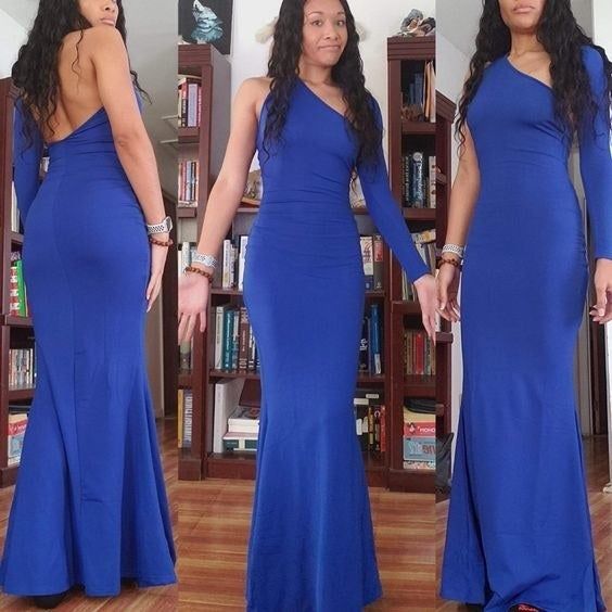 reviewer showcasing the front and back of the one-sleeve, dipped-back gown in blue