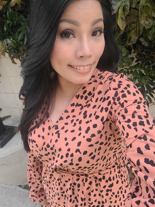A reviewer wearing the dress in pink