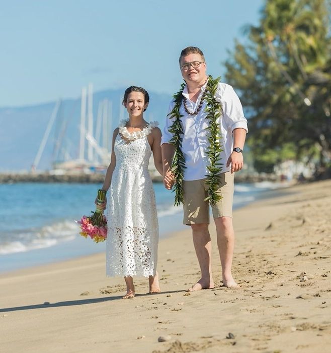 A reviewer in the white V-neck frock, praising its elegant design, flattering fit, and versatility for various occasions.