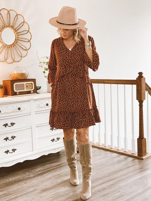 reviewer in a brown dress