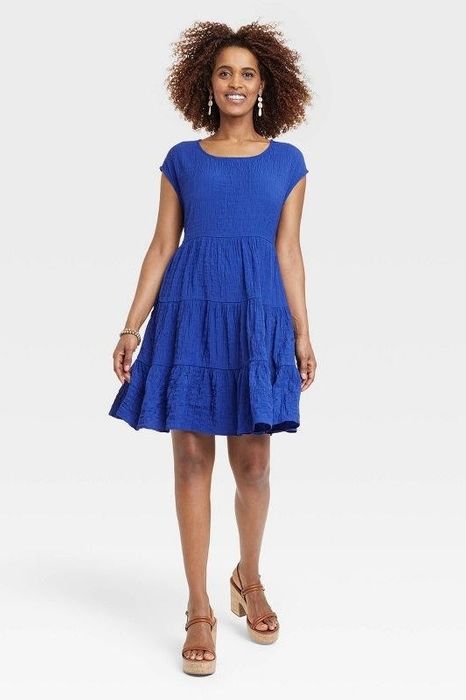 Model showcasing the navy blue dress