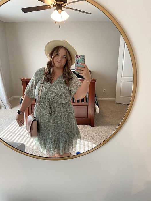 A reviewer wearing the green dress