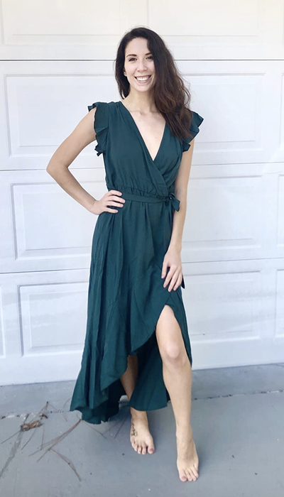 A reviewer showcasing the green dress