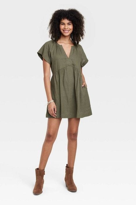 Model showcasing the olive green dress
