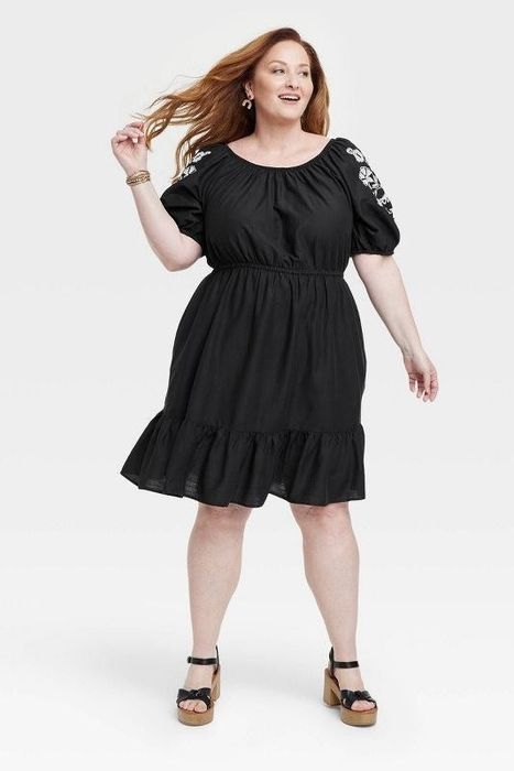 Model showcasing the black dress
