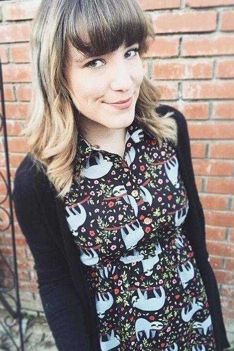 A reviewer styled in the dress paired with a sleek black sweater