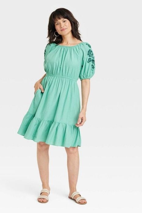 Model showcasing the light green dress
