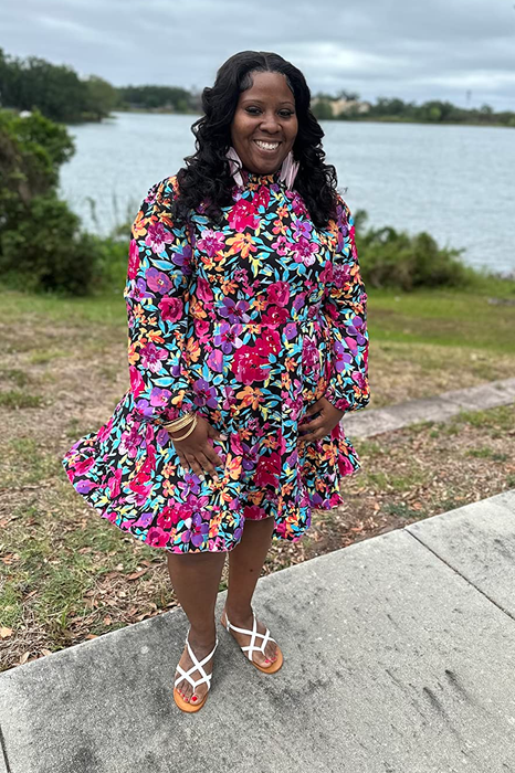 reviewer wearing a pink floral mini dress