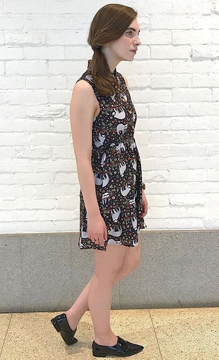A model showcasing the dress featuring a sophisticated collared neckline