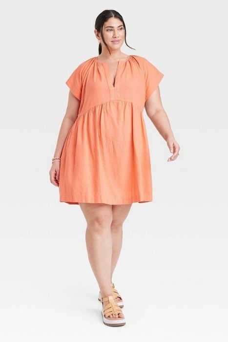 Model showcasing the orange dress