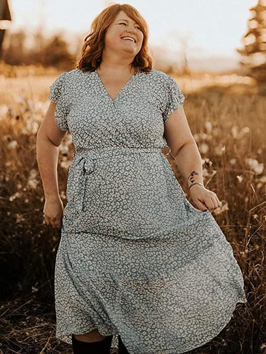A reviewer wearing the light blue and white dress