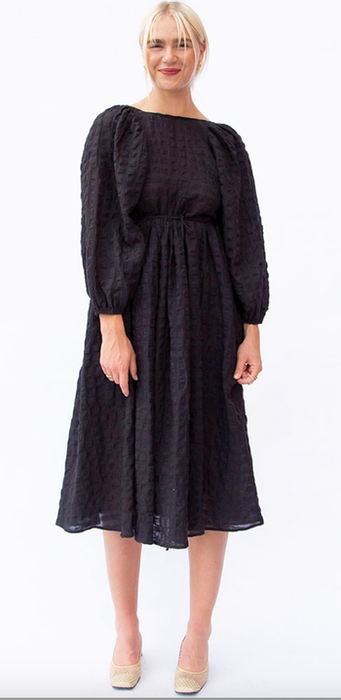 model wearing the black dress with a scoop neckline