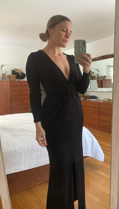 reviewer wearing a black V-neck bodycon dress