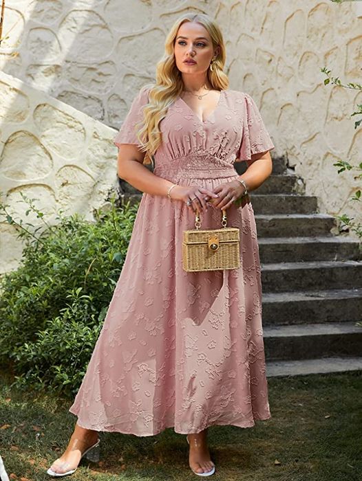A model wearing the dress in a soft light pink shade