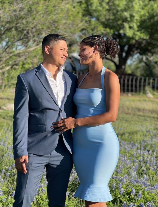 A reviewer in the light blue knee-length midi, highlighting its versatility and perfect fit for various occasions.