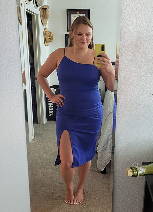 A reviewer wearing the spaghetti strap blue midi dress