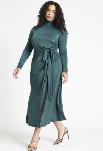 front view of a model in a green mock neck midi dress