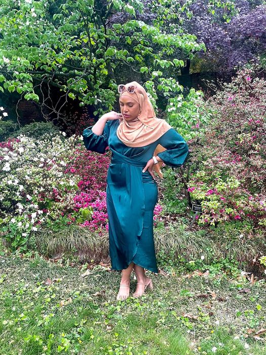 reviewer wearing a teal satin midi dress