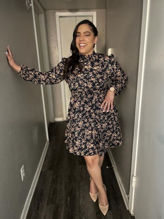 another reviewer in a black and gold floral mini dress