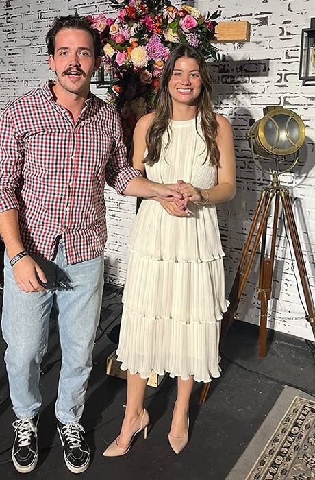 A reviewer wearing the off-white pleated dress