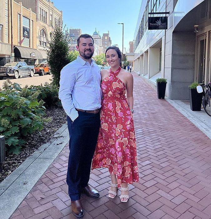 A reviewer wearing a halter pink floral-print maxi dress, sharing their experience with its fit, style, and overall appeal.