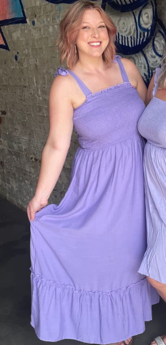 A reviewer wearing the purple dress
